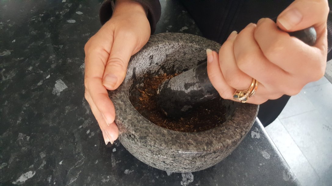 woman using a pestle and mortar